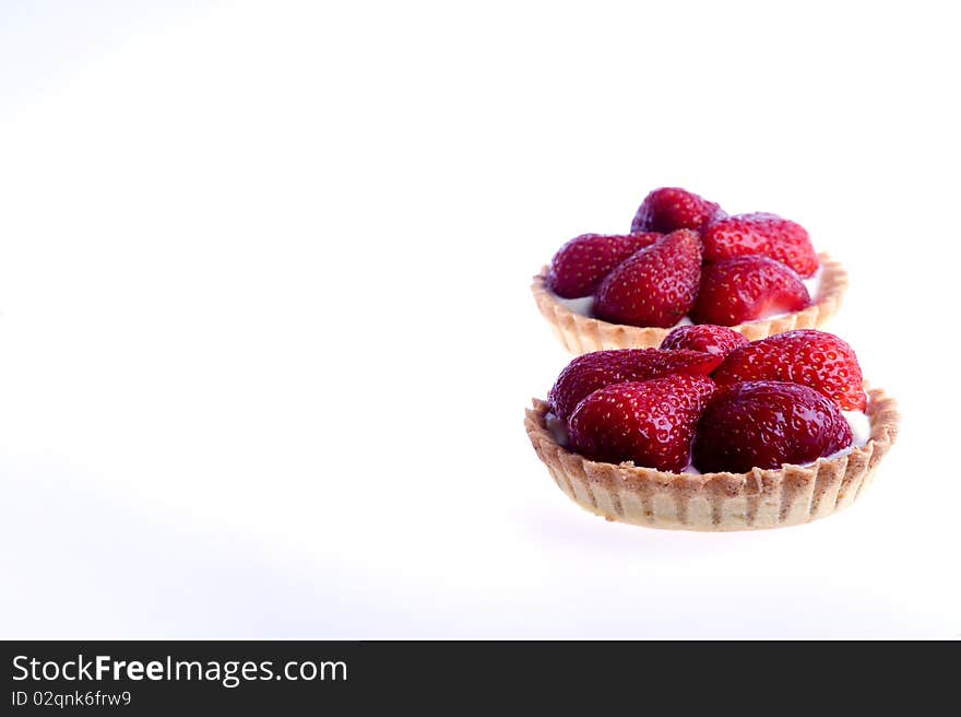 Studio shot of strawberry tarts isolated on a white background.