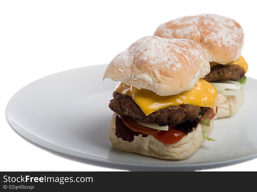 Home made burgers on a plate isolated on a white background