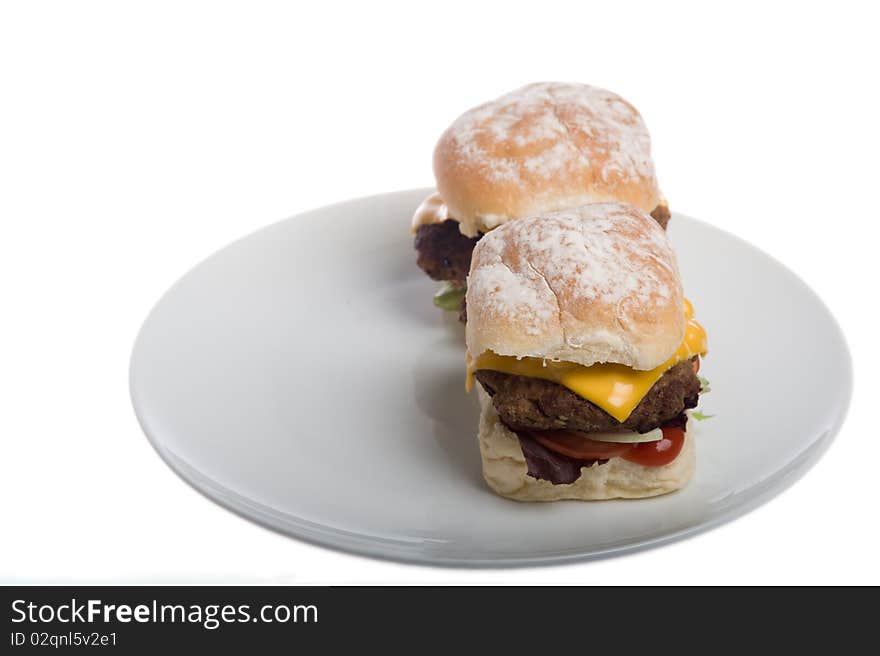 Home made burgers on a plate isolated on a white background