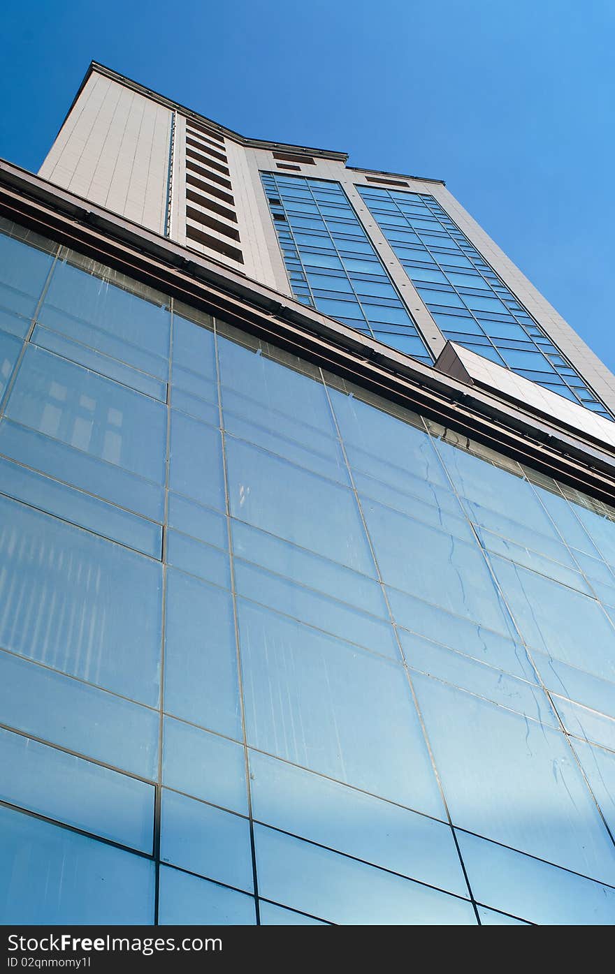 Building with the blue windows against summer sky. Shallow DOF