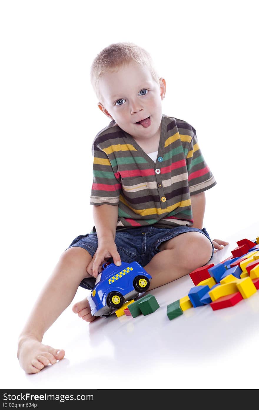 The kid plays with cubes on a white background