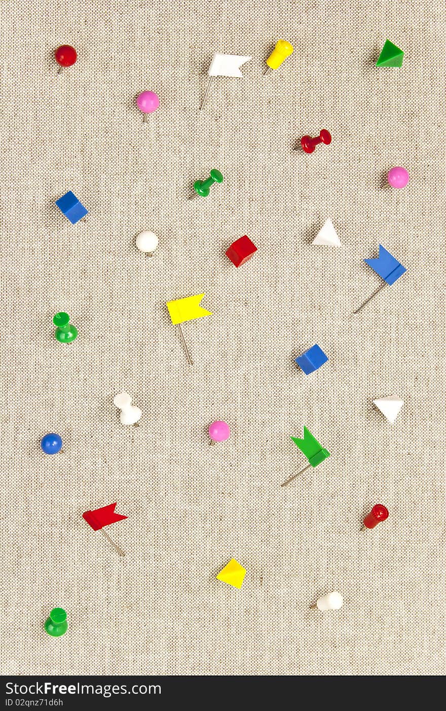 Colorful pushpins in various angles.