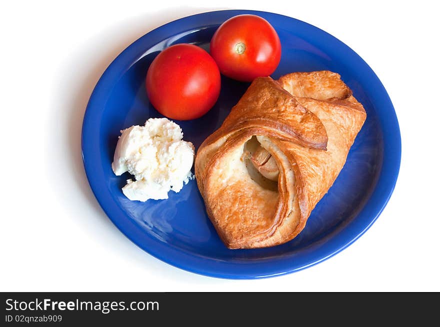 Croissant, cream cheese and tomatoes on the plate insulation. Croissant, cream cheese and tomatoes on the plate insulation