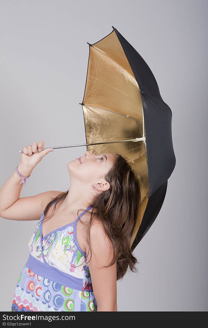 Young girl playing with an umbrella