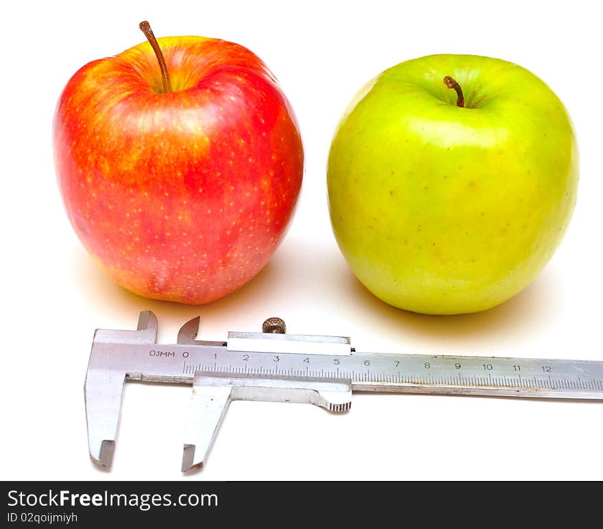 Red and green apples with the tool for measurement. Red and green apples with the tool for measurement