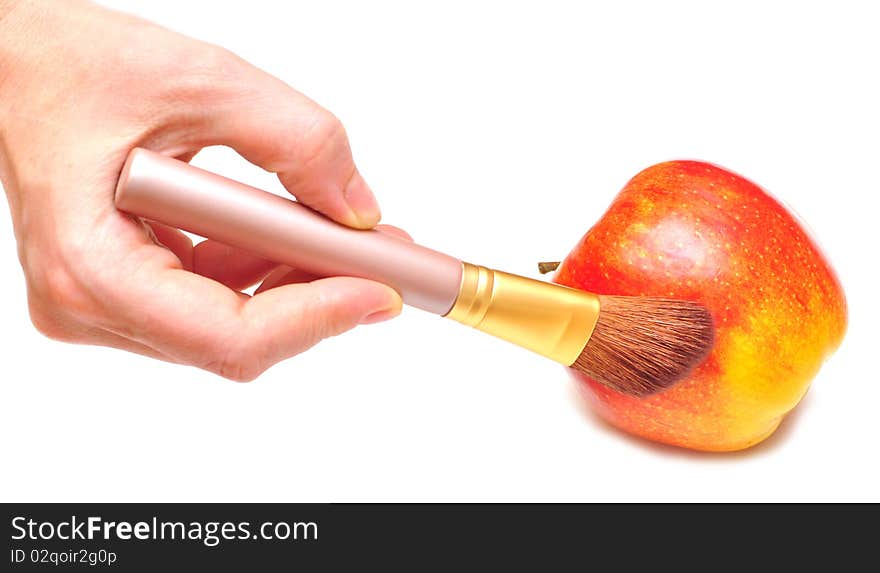 Hand paints with brush this apple