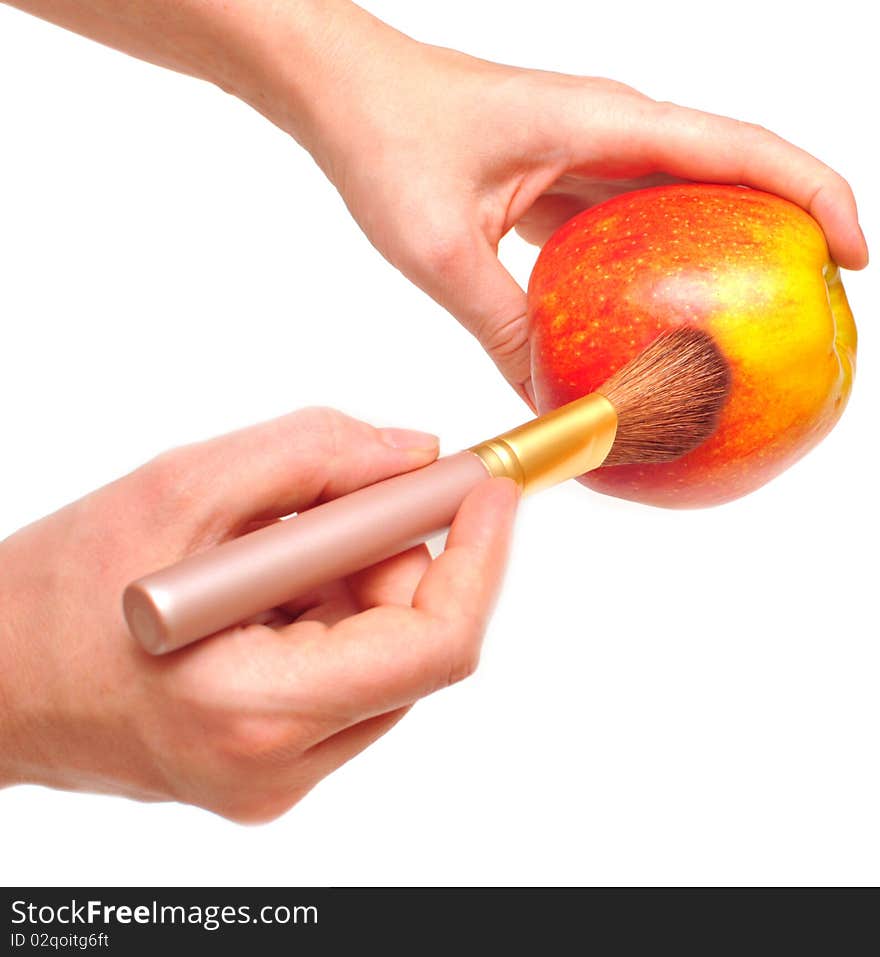 Artist holds an apple on a hand and paints it in red color. Artist holds an apple on a hand and paints it in red color