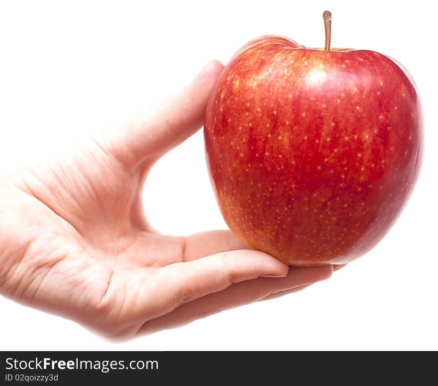 Juicy red apple in graceful woman's hand. Juicy red apple in graceful woman's hand