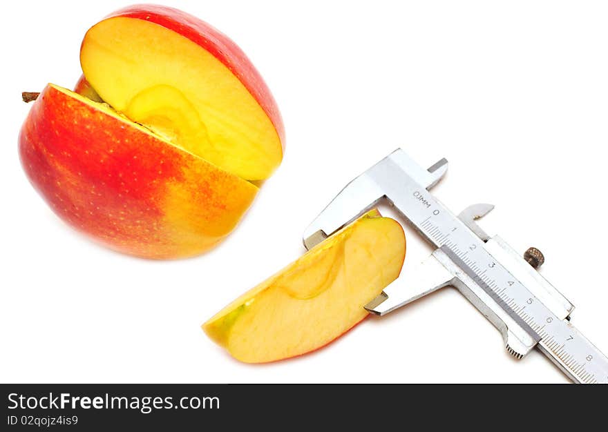 Slice of red apple is measured