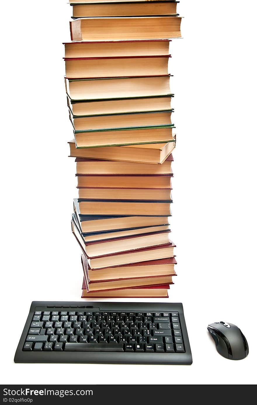 Black keyboard and mouse near books hill. Isolated on white. Black keyboard and mouse near books hill. Isolated on white