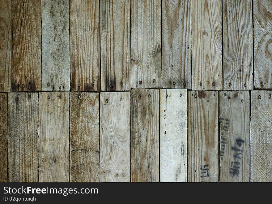 Background, a wall knocked together from wooden planks