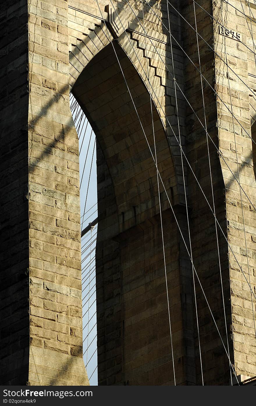 Brooklyn Bridge, New York City on a bright sunny day with patchy clouds.