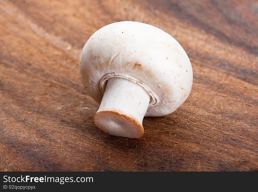 Detail of fresh champignon on a chopping board. Detail of fresh champignon on a chopping board