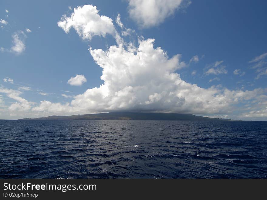 Clouds over island at ocean. Clouds over island at ocean