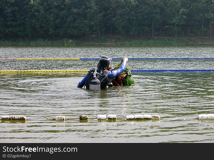 Divers emerge out from lake water, Sumarice lake Kragujevac, Serbia