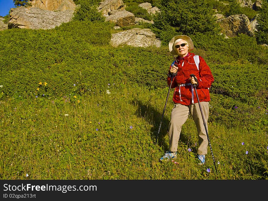 Old women with mountains flowers. Old women with mountains flowers