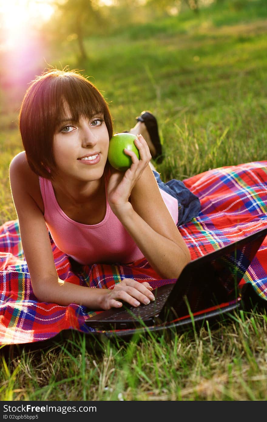 Lovely girl with laptop in the park