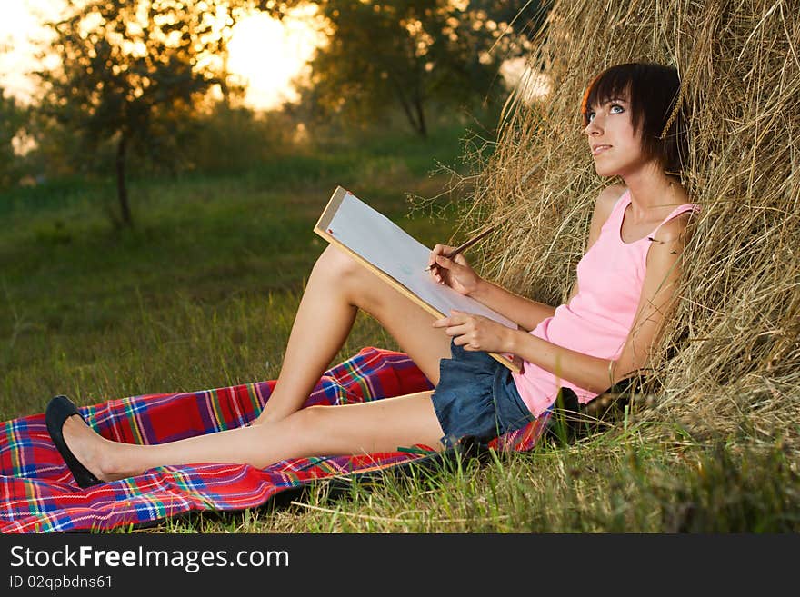 Lovely girl drawing in the park