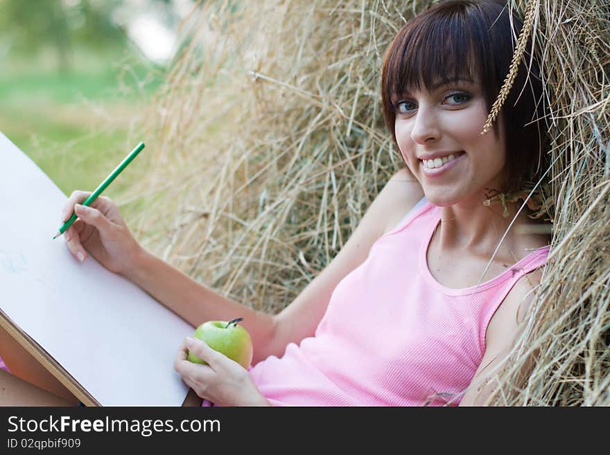 Lovely girl having rest and drawing in the park. Lovely girl having rest and drawing in the park