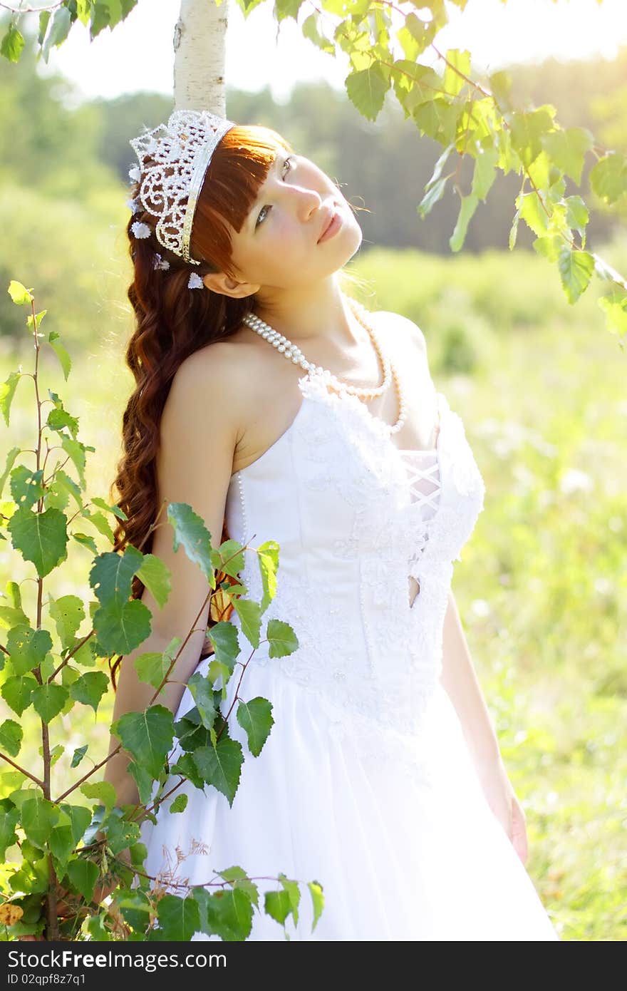 Beautiful girl near to a birch