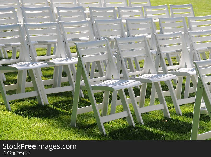 Empty chairs on yard grass