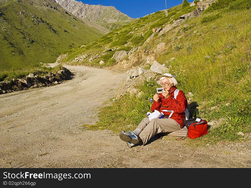 Old women with mountains flowers. Old women with mountains flowers