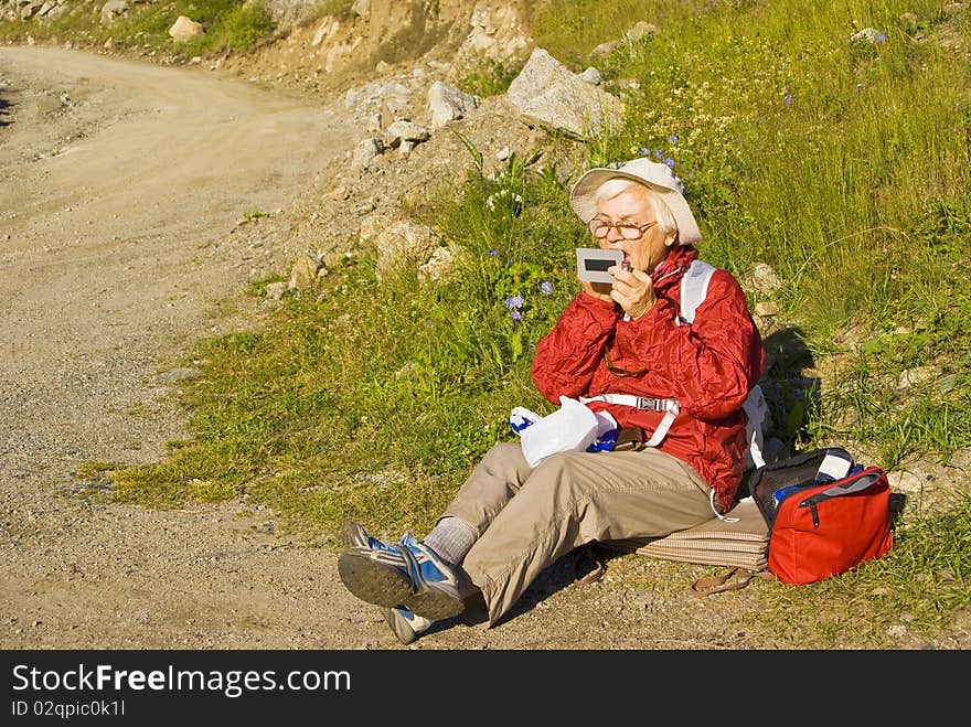 Old women with mountains flowers. Old women with mountains flowers