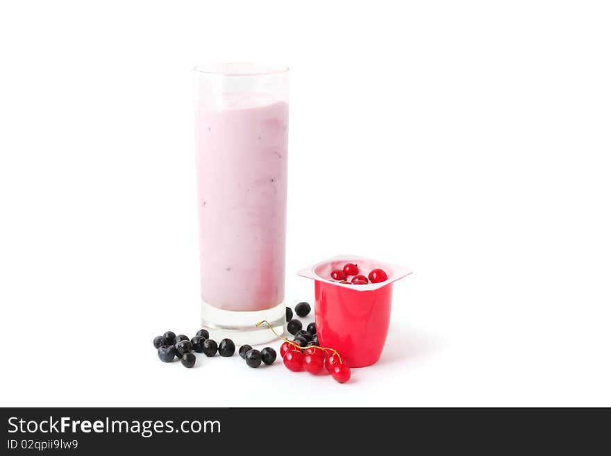 Berry yogurts in a glass and plastic package with blueberries and red currant. Berry yogurts in a glass and plastic package with blueberries and red currant