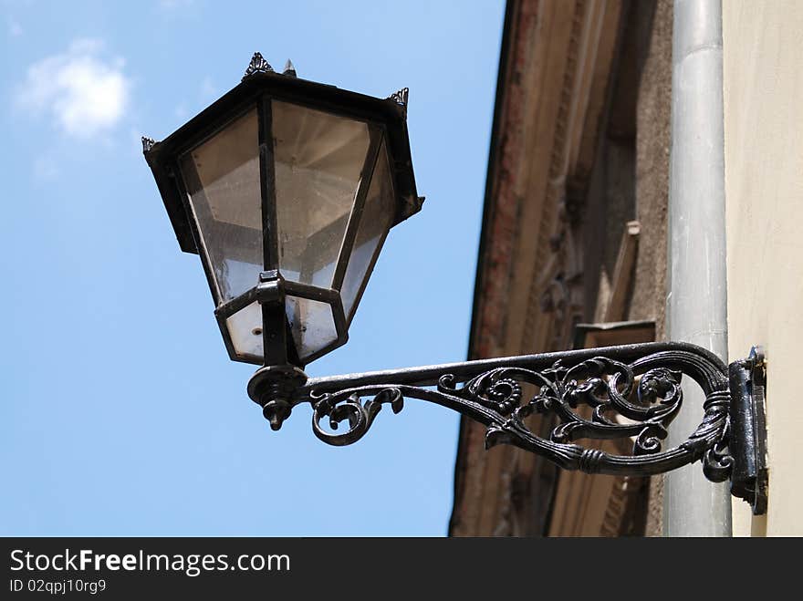 Street Lamp on a high metal lamppost with blue sky background