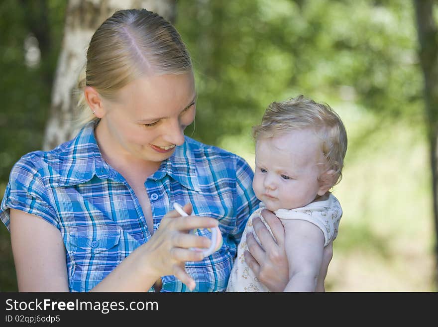 Mother playing with her baby outdoors