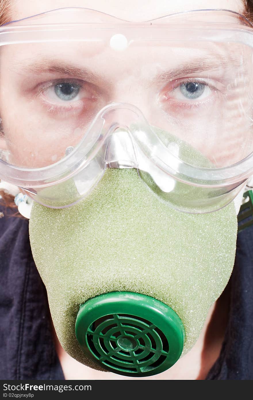 Man closeup in a respirator and safety glasses. Man closeup in a respirator and safety glasses