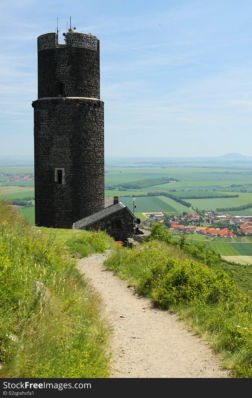 Path through grass to the ancient stony tower. Path through grass to the ancient stony tower