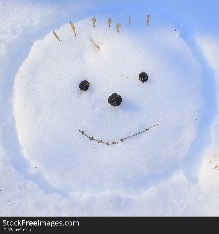 Smiling face hand-made snow picture. Smiling face hand-made snow picture