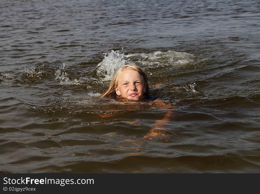 Girl swimming in the sea. Girl swimming in the sea.