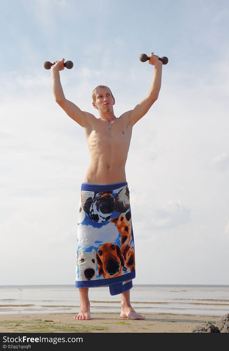 Gymnast training on the beach. Gymnast training on the beach.