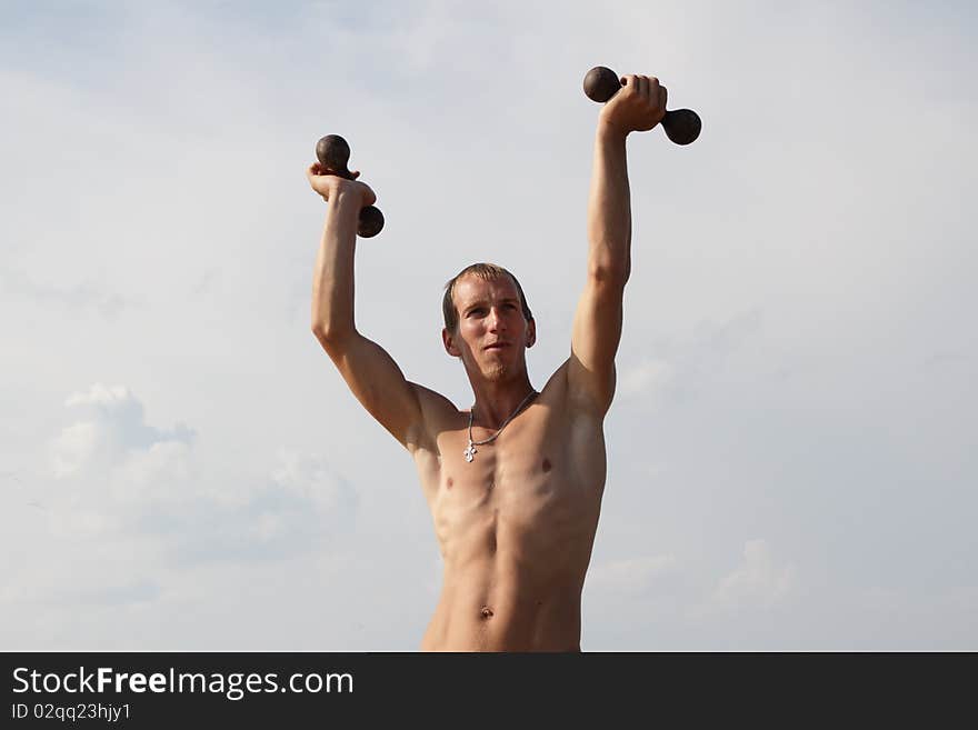 Young and healthy man exercising outdoors. Young and healthy man exercising outdoors.