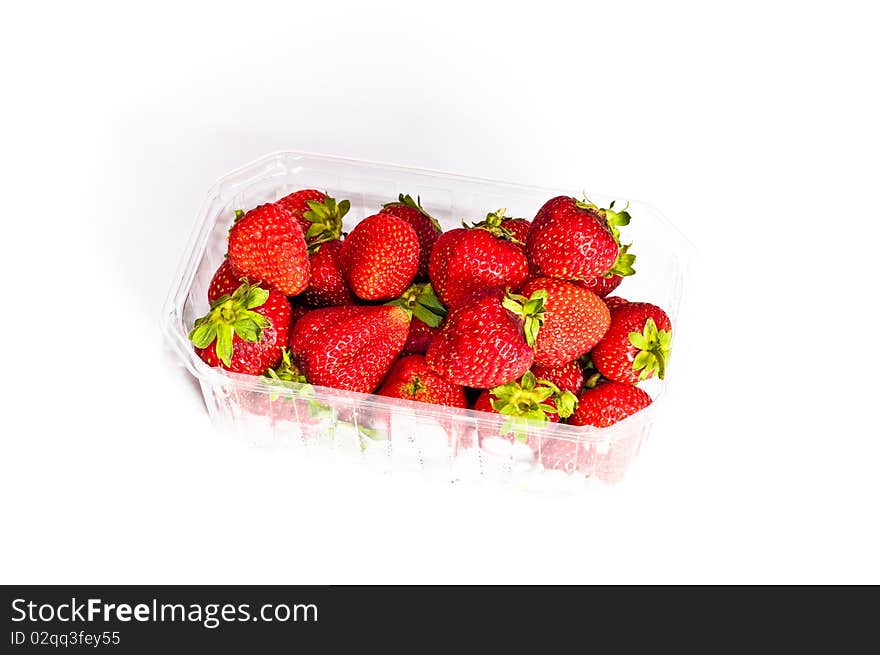 Strawberries isolated on white background in transparent, bright box. Strawberries isolated on white background in transparent, bright box