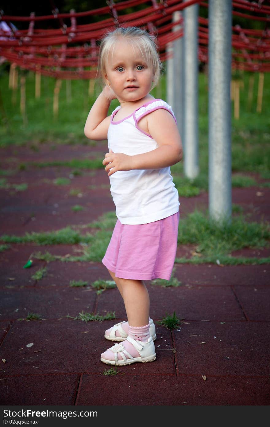 Beautiful small blonde girl on playground. Beautiful small blonde girl on playground