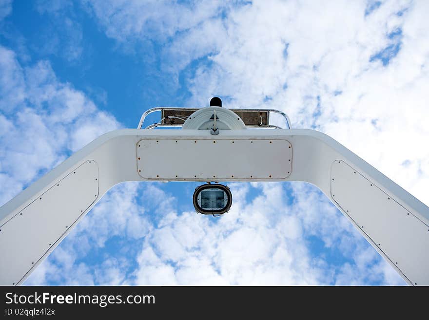 Boat Radar Mast Against Clouds