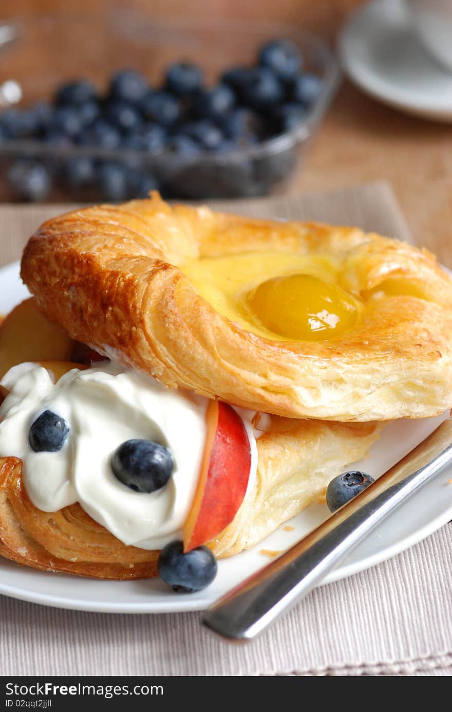 Fruit Danish with creme fraiche and fruit on a plate