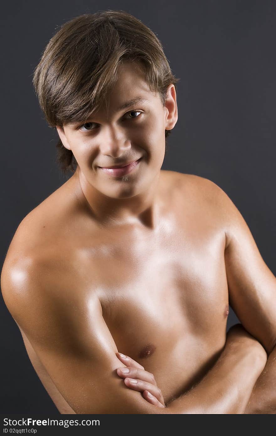 man with naked torso posing against dark background. man with naked torso posing against dark background