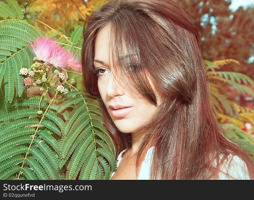 Lovely beautiful woman, enjoying in the sun on green garden