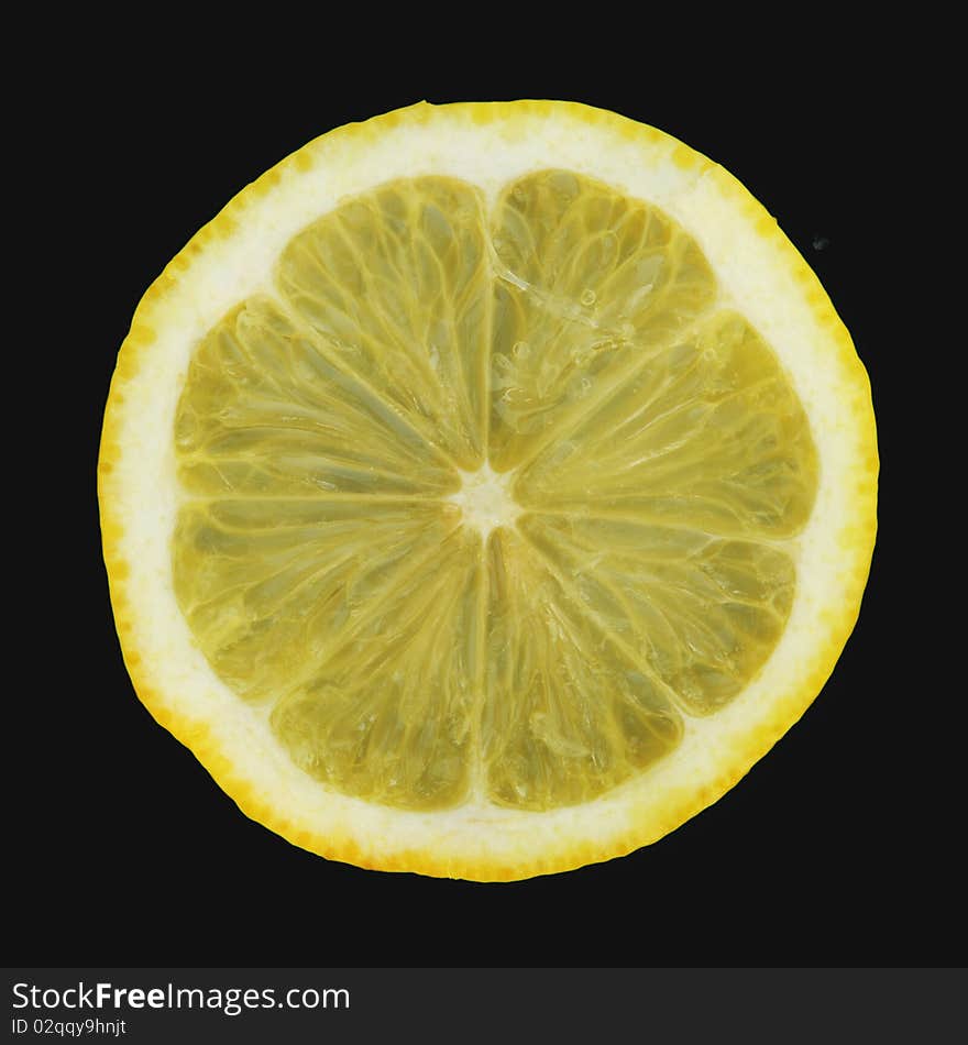 Slice of ripe lemon isolated on black. Slice of ripe lemon isolated on black