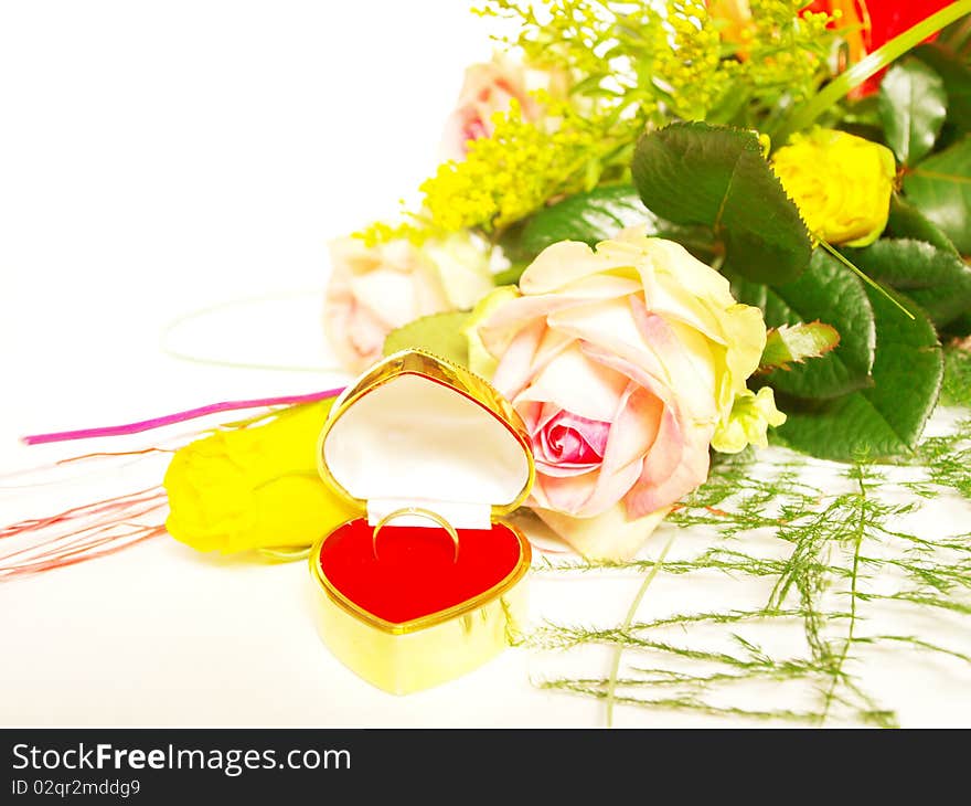 Rose and wedding ring in a box