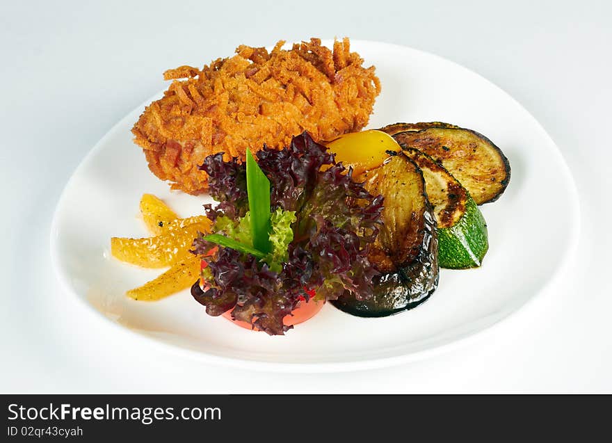 Grilled slices of aubergine and vegetable marrow on a white plate