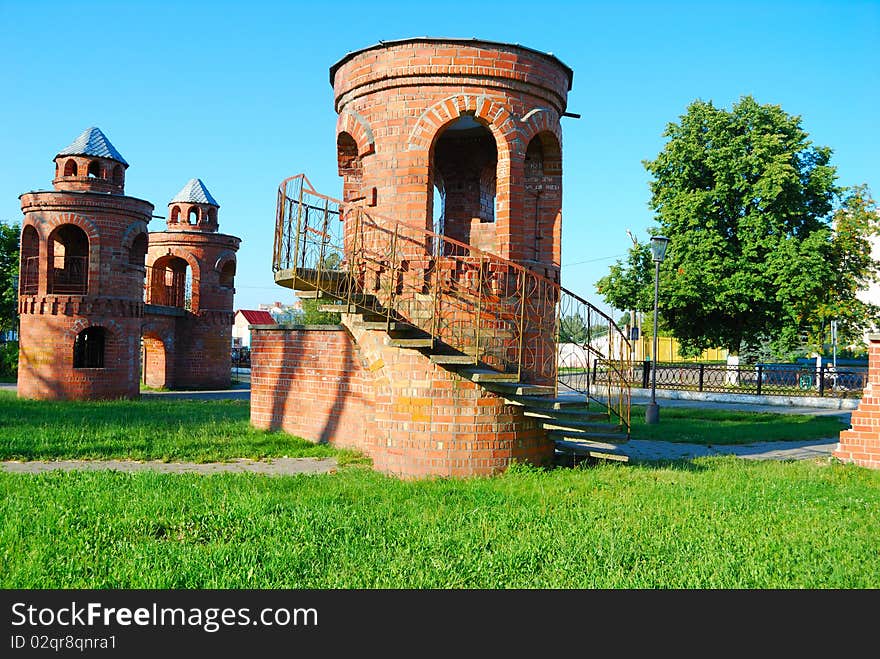 Tower from a red brick on a lawn in park
