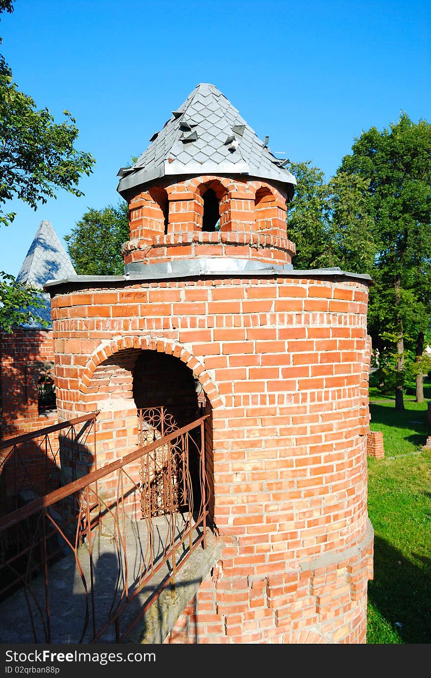 Tower from a red brick on a lawn in park