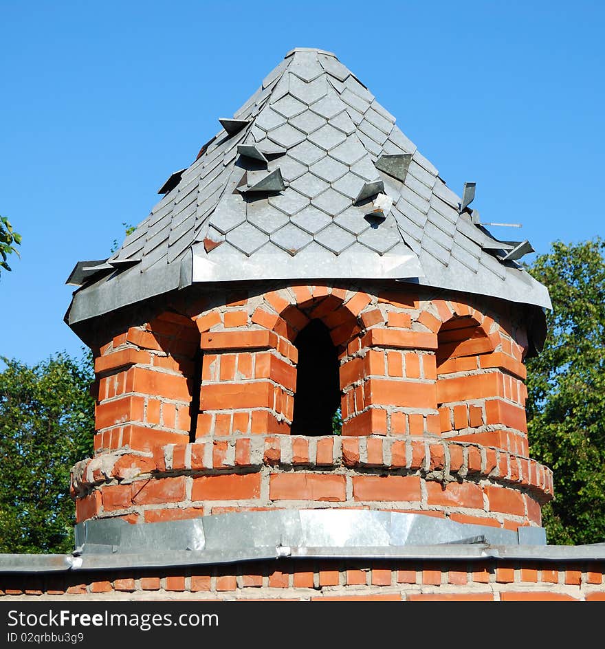 Tower from a red brick on a lawn in park