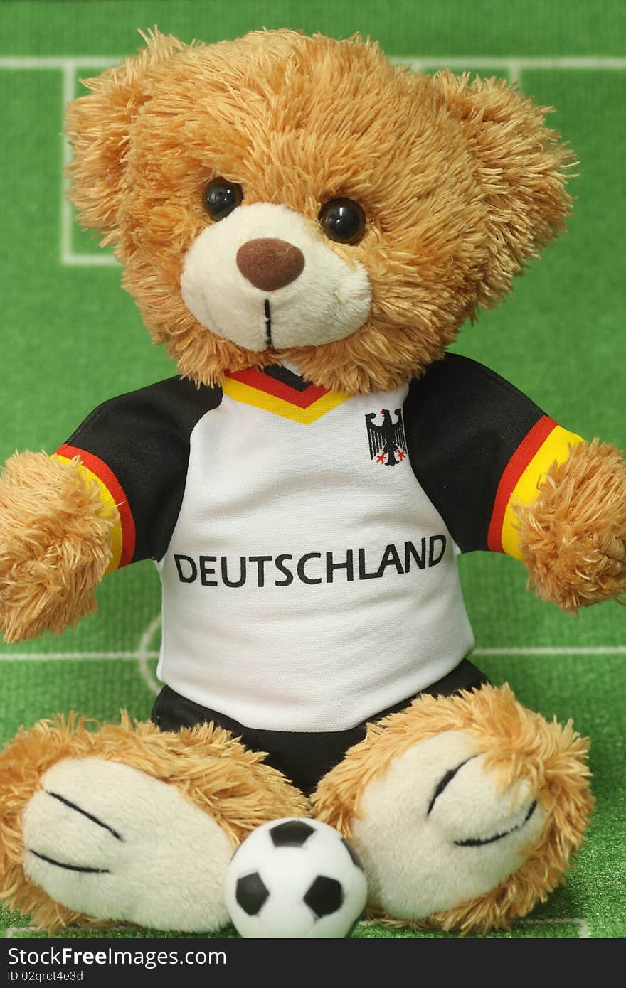 Teddy bear with football shirt on lawn background. Teddy bear with football shirt on lawn background