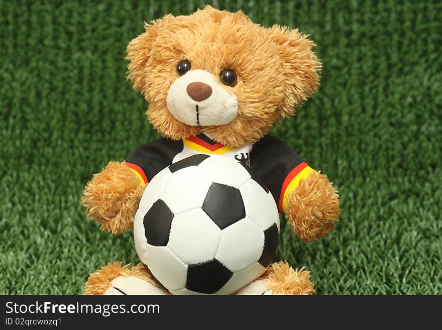 Teddy bear with football shirt on lawn background. Teddy bear with football shirt on lawn background